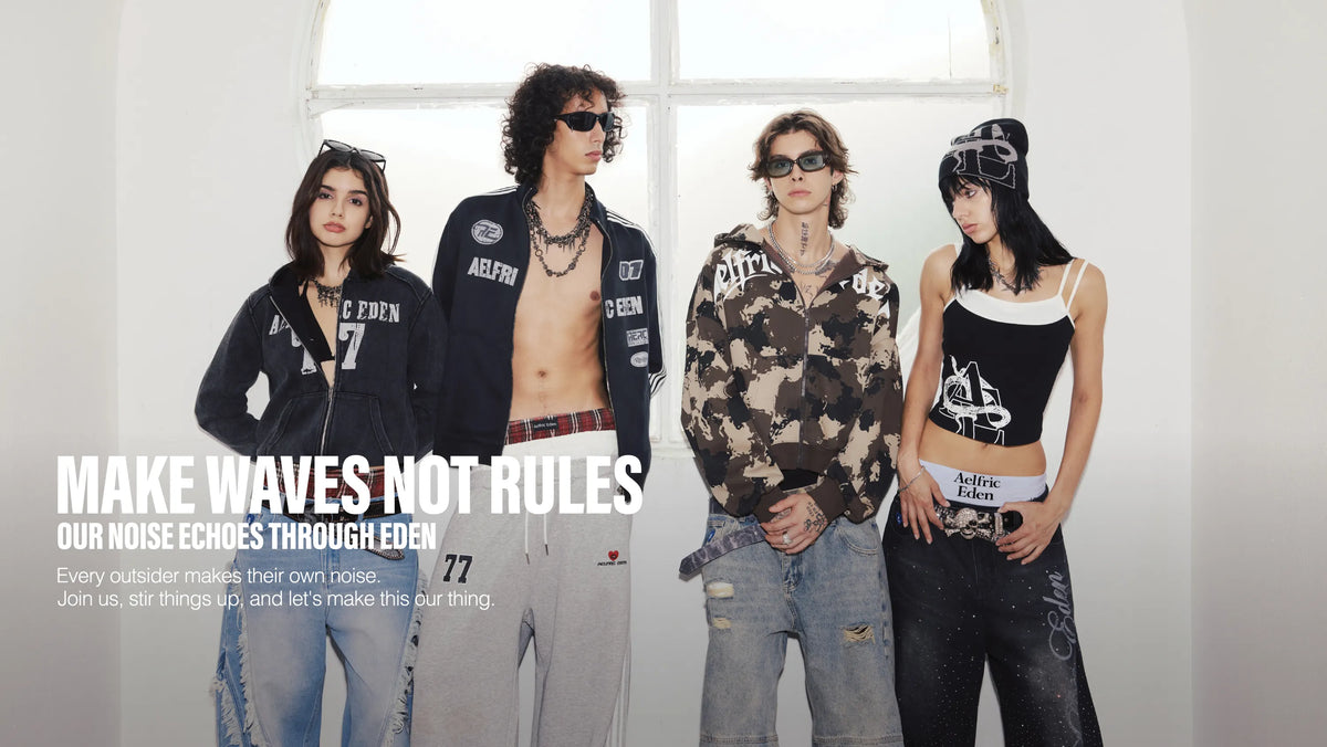 A rock band performs live in a bright white studio with arched windows. The lead singer wears sunglasses and a black-and-white jacket while holding a microphone, with a bassist, guitar player, and keyboardist behind him. 
"MAKE WAVES NOT RULES "THEME.